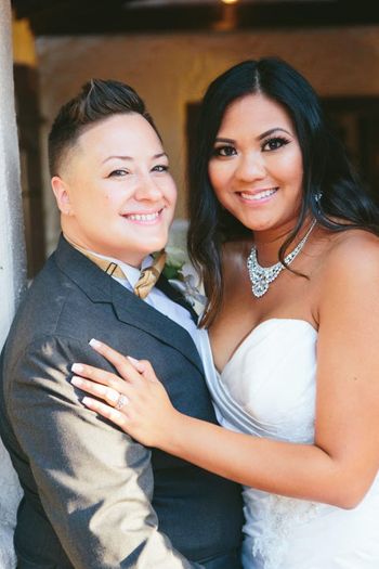 Dapper Boi Founder's Vicky (pictured in suit) and Charisse (pictured in dress) at their wedding. dapperBoi.com