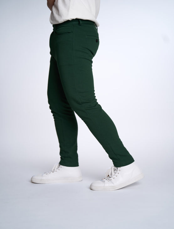 Person wearing Dapper Boi slim casual knit pants in green, side view